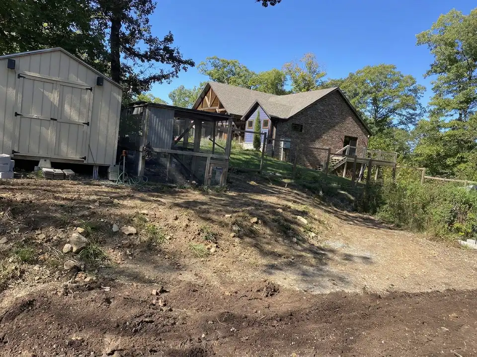 Before the work: block retaining wall across a backyard slope