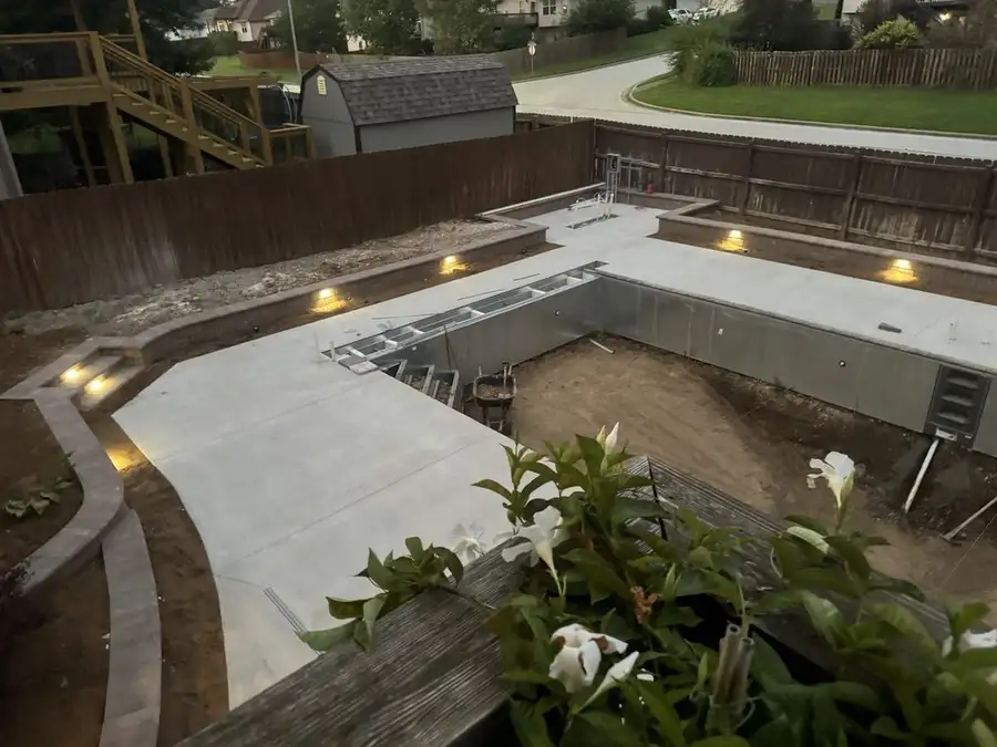 Pool going in, with the deck poured and lights in the block walls