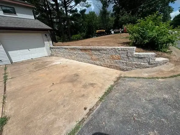 Block wall and steps beside a driveway
