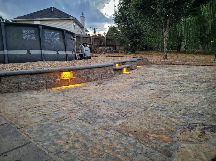 Lights set under the cap of a patio wall